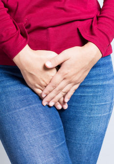 Woman with Hands Holding her Crotch Isolated in a White Background